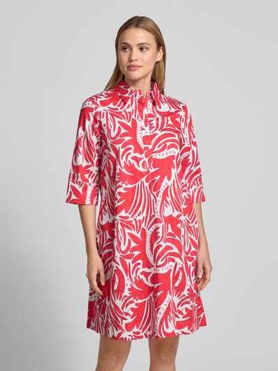 Frauenmodel trägt Knielanges Hemdblusenkleid mit verdeckter Knopfleiste von Christian Berg Woman in Rot-Weiß, Reine Baumwolle, Straight Fit, Hemdblusenkragen, Knielänge, 1/2-Arm, Ganzkörperansicht von vorne.