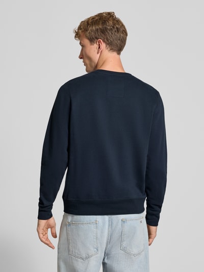 Männermodel trägt Regular Fit Sweatshirt aus Baumwoll-Mix mit Logo-Stickerei von Superdry, dunkelblau, glatte Struktur, Ganzkörperansicht Rückansicht.