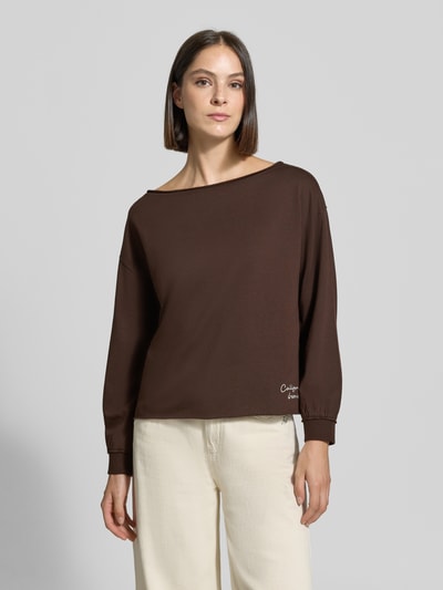 Frauenmodel trägt Relaxed Fit Pullover aus Baumwoll-Mix von Smith and Soul in Dunkelbraun, U-Boot-Ausschnitt, Statement-Stitching, elastische Ärmelabschlüsse, Ganzkörperansicht von vorne.