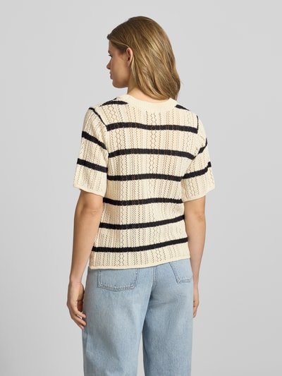 Frauenmodel trägt Regular Fit Strickshirt aus reiner Baumwolle Modell 'NUKA' von Pieces, Optik:Allover-Muster, gestreift, Lochstrick, Ganzkörperansicht Rückansicht.