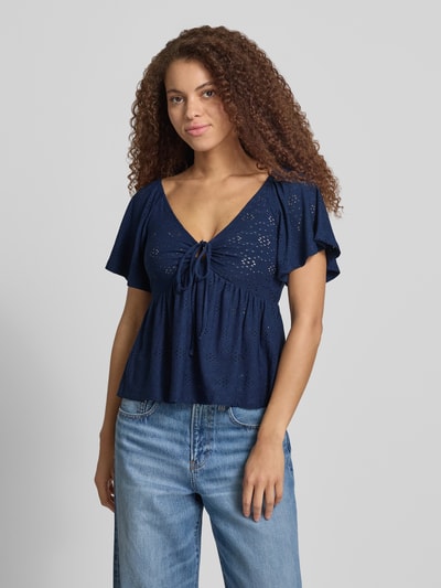 Frauenmodel trägt Damen T-Shirt von Only, Slim Fit T-Shirt mit tiefem V-Ausschnitt Modell 'SMILLA' in Semitransparent-Optik, florales-Muster, Kurzarm, Stretch-Materialverarbeitung, Ganzkörperansicht von vorne.