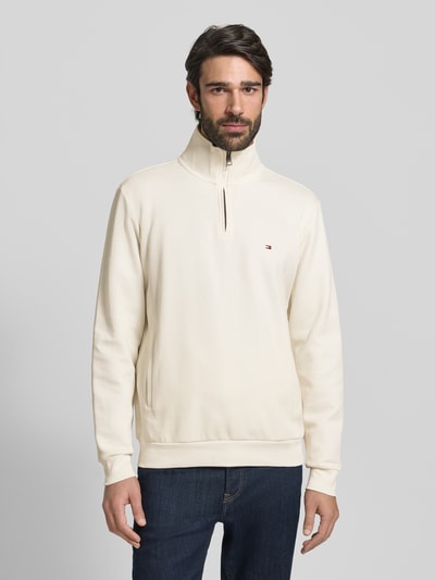 Männermodel trägt Regular Fit Troyer aus Baumwoll-Mix von Tommy Hilfiger, Optik: Unifarben, Label-Stitching-Applikation, Reißverschluss, Langarm, gerippte Abschlüsse, Material: Baumwoll-Mix, Ganzkörperansicht von vorne.