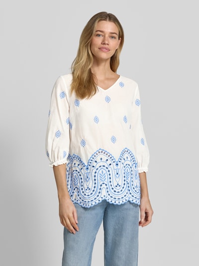 Frauenmodel trägt Relaxed Fit Bluse mit Lochstitching in Paisley-Optik von More & More aus Baumwoll-Mix mit V-Ausschnitt, 3/4-Arm, Rückenlänge 66 cm, Ärmellänge 45 cm, weiß-blau gemustert, strukturierte Oberfläche, Ganzkörperansicht von vorne.