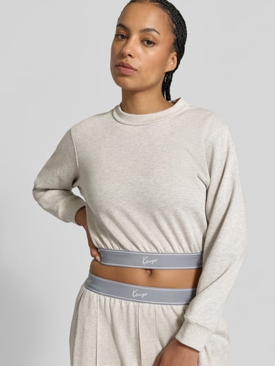 Frauenmodel trägt Cropped Sweatshirt mit Logo-Stitching von Kenzo in Beige, reine Baumwolle, elastische Abschlüsse, Rundhalsausschnitt, Nahaufnahme Oberkörper.