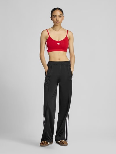 adidas Originals Spodnie dresowe o kroju loose fit z paskami w kontrastowym kolorze Czarny 1
