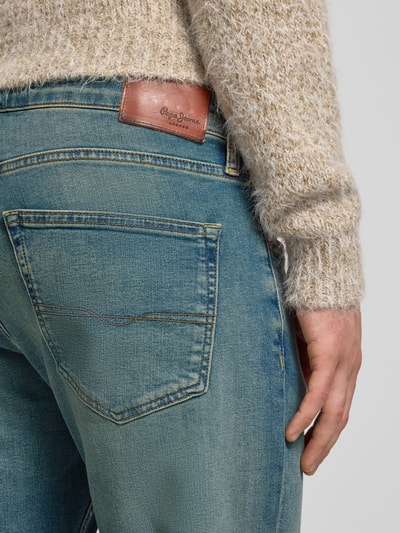 Männermodel trägt Straight Fit Jeans aus Baumwoll-Mix Modell 'CASH' von Pepe Jeans in Denim-Optik mit Label-Patch, Nahaufnahme Rückansicht.
