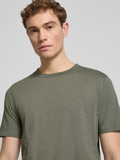 Männermodel trägt Regular Fit T-Shirt aus reiner Baumwolle Modell 'TEGOOD' von BOSS Orange in Unifarben, Nahaufnahme Oberkörper.
