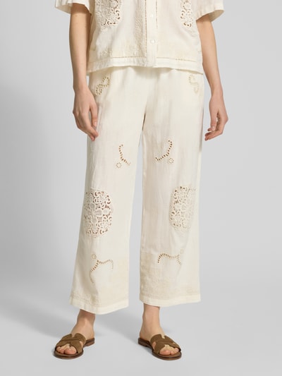 Kobiece model prezentuje Culotte mit Lochstickerei und Eingrifftaschen od Jake*s Casual z lnu i bawełny, kremowy kolor, haft ażurowy, szerokie nogawki, elastyczny pas z troczkiem, francuskie kieszenie boczne, szerokość w rozmiarze 38: 40 cm, długość nogawki wewnętrznej w rozmiarze 38: 67 cm, zdjęcie w całej sylwetce z przodu.