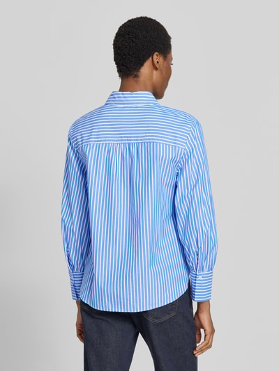 Frauenmodel trägt Regular Fit Hemdbluse aus reiner Baumwolle Modell 'VIC' von Brax mit blau-weißem Streifenmuster, feine Webstruktur, Ganzkörperansicht Rückansicht.