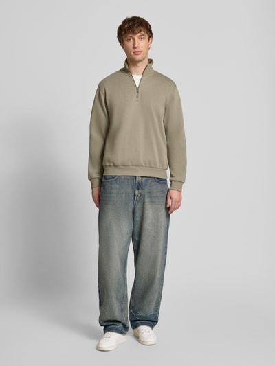 Männermodel trägt Regular Fit Sweatshirt mit Troyer-Kragen Modell 'Bradley' von Jack & Jones in Beige, Material-Mix, Ganzkörperansicht von vorne.