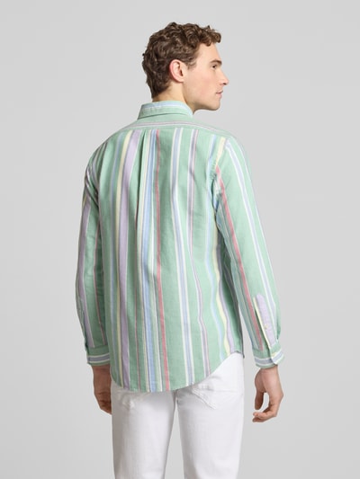 Männermodel trägt Regular Fit Freizeithemd aus reiner Baumwolle von Polo Ralph Lauren mit grünem, gestreiftem Allover-Muster, Ganzkörperansicht Rückansicht.