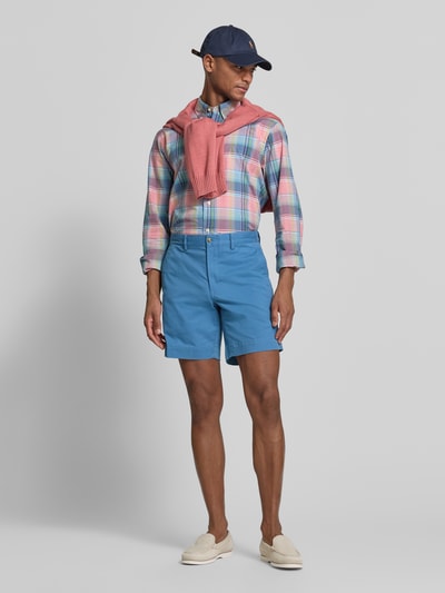 Männermodel trägt Straight Fit Chinoshorts aus Baumwoll-Mix von Polo Ralph Lauren, Optik: Unifarben, Logo-Detail, Ganzkörperansicht von vorne.