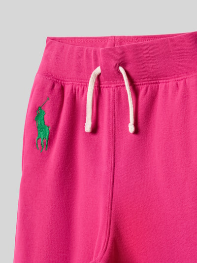 Productfoto, Wide Leg Sweatpants aus Baumwoll-Mix van Polo Ralph Lauren Kids in effen roze met logodetail, tunnelkoord, steekzakken, sweat katoenmix.