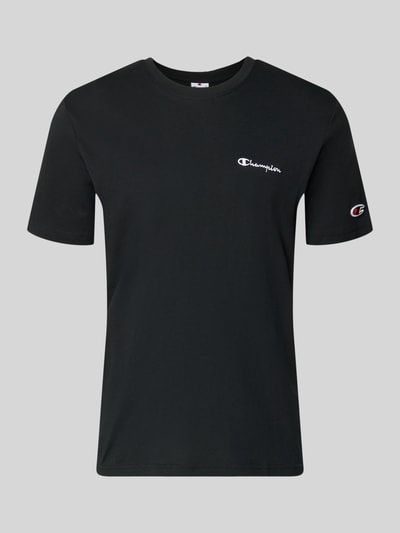 Produktfoto, T-Shirt mit Label-Stitchings und Rundhalsausschnitt von CHAMPION in Schwarz, reine Baumwolle, Regular Fit, schlichte Struktur.