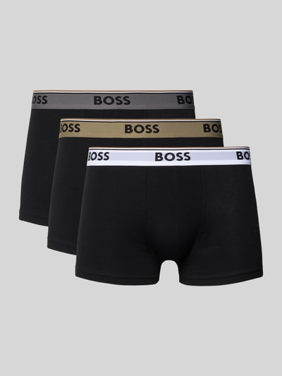 Produktfoto, Trunks aus Baumwoll-Mix im 3er-Pack von BOSS, Optik: Unifarben, Passform: Regular-Fit, Label-Bund, Bundabschluss: elastisch, Multipack: 3er-Pack, Material: Baumwoll-Mix, schwarze Trunks mit verschiedenfarbigen Label-Bündchen vor grauem Hintergrund.