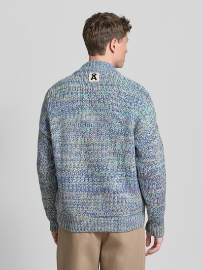 Männermodel trägt Relaxed Fit Strickjacke aus Baumwoll-Woll-Mix mit Viskose-Anteil Modell 'UN-WASTED' von Armedangels, mehrfarbig, Strickoptik, Stehkragen, langarm, gerippte Abschlüsse, Logo-Detail, Ganzkörperansicht Rückansicht.