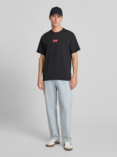 Męskimodel nosi Regular Fit T-Shirt aus reiner Baumwolle von Levi's®, czarny kolor, prosta forma, gładka faktura, Ganzkörperansicht von vorne.