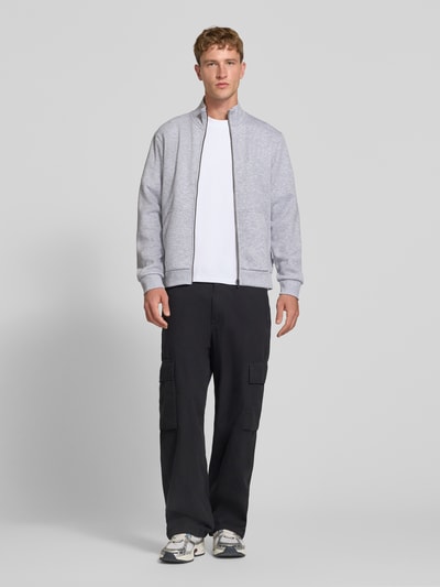 Männermodel trägt Regular Fit Sweatjacke mit Baumwoll-Anteil Modell 'Bradley' von JACK & JONES in Grau, Material-Mix, Ganzkörperansicht von vorne.