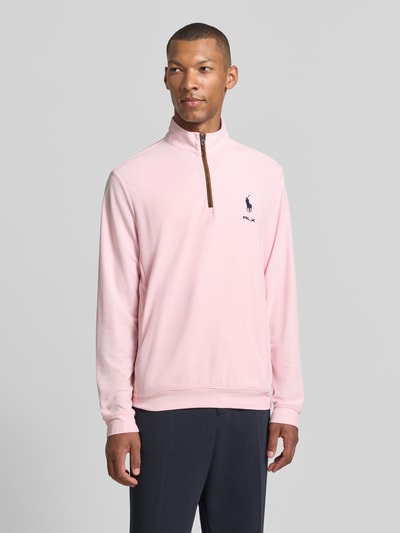 Männermodel trägt Regular Fit schipperstrui met korte ritssluiting van Polo Ralph Lauren in lichtroze, Ganzkörperansicht von vorne.