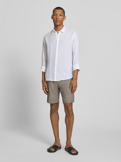 Männermodel trägt Regular Fit Chinoshorts aus Baumwoll-Leinen-Mix Modell 'BRODY' von SELECTED HOMME in Beige, Ganzkörperansicht von vorne.