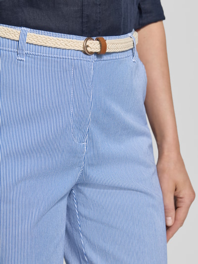 Frauenmodel trägt Chino-Bermudas mit Gürtel von Christian Berg Woman aus Baumwoll-Elasthan-Mix, Allover-Look, Nahaufnahme Oberkörper.