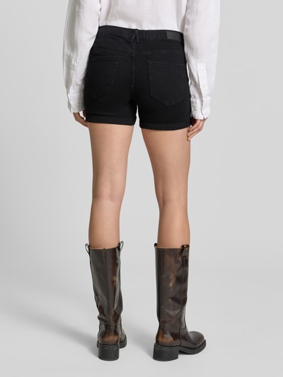 Frauenmodel trägt Regular Fit Jeansshorts aus Baumwoll-Mix Modell 'LUNA' von Vero Moda in schwarzer Denim-Optik, 5-Pocket-Design, Ganzkörperansicht Rückansicht.