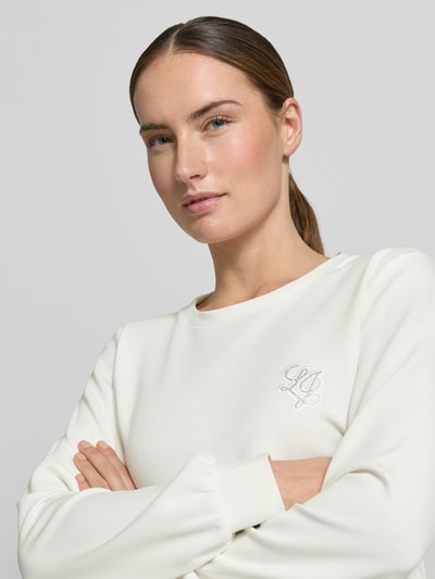 Frauenmodel trägt Sweatshirt aus Modal-Mix mit Rundhalsausschnitt von LIU JO SPORT in Creme mit Logo, Regular-Fit, Nahaufnahme Oberkörper.