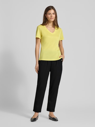 Frauenmodel trägt Straight Fit Stoffhose mit Viskose-Anteil von LIU JO SPORT in Schwarz, Material-Mix, 7/8-Länge, elastischer Bund, Zierbesatz, Ganzkörperansicht von vorne.