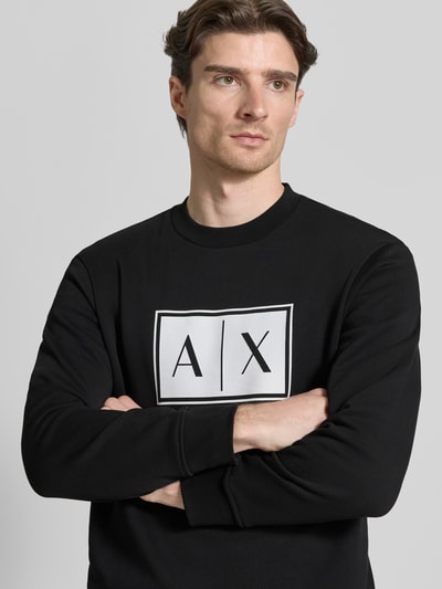 Męski model nosi Sweatshirt mit Logo-Print und Rundhalsausschnitt von ARMANI EXCHANGE, czarny, bawełna, krój loose fit, zbliżenie na górną część ciała