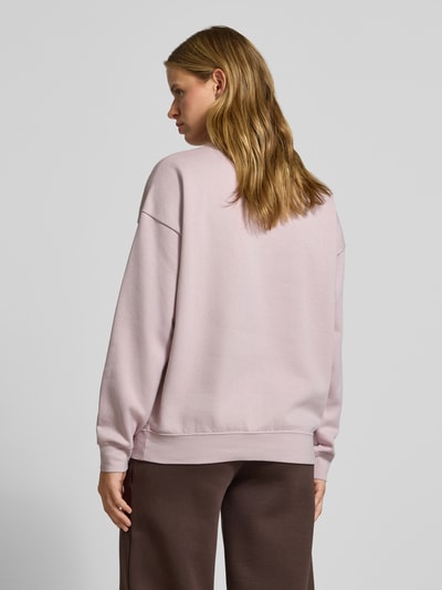 Frauenmodel trägt Oversized Sweatshirt aus Baumwoll-Mix Modell 'ESS OVERSIZED' von PUMA in blassem Rosa, glatte Oberfläche, Damen Sweatshirt, Ganzkörperansicht Rückansicht.