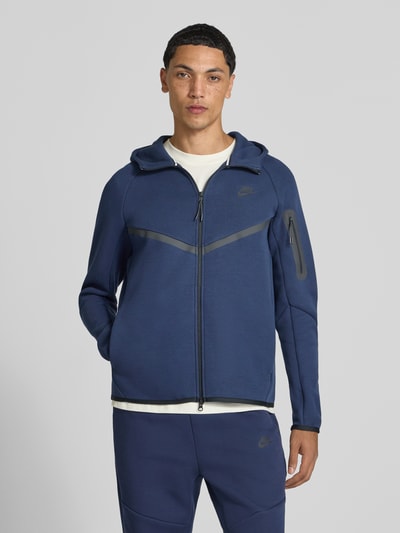 Mężczyzna nosi Regular Fit Sweatjacke aus Baumwoll-Mix von Nike, granatowa bluza rozpinana, prosta faktura, Ganzkörperansicht von vorne.