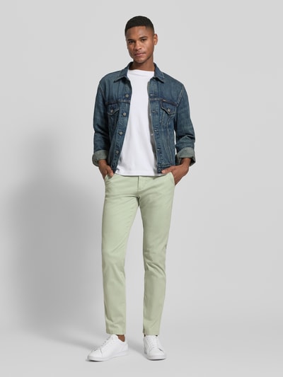Männermodel trägt Chino mit Eingrifftaschen von Lindbergh, Slim Fit, mintgrün, aus Baumwoll-Elasthan-Mix, Ganzkörperansicht von vorne.