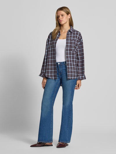 Frauenmodel trägt Flared Jeans mit Knopfverschluss Modell 'ROME' von JJXX in mittlerem Blau, Baumwoll-Mix mit Stretch, 5-Pocket-Design, Ganzkörperansicht von vorne.