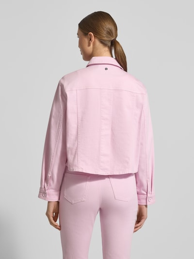 Frauenmodel trägt Jeansjacke mit Knopfleiste und Brusttaschen von Marc Cain in Rosa aus Baumwoll-Elasthan-Mix, Boxy Fit, Ganzkörperansicht Rückansicht. Rückenlänge 51 cm, Schulterbreite 47 cm, Brustweite 54 cm, Ärmellänge 56 cm bei Größe 36.