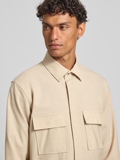 Männermodel trägt Relaxed Fit Hemdjacke mit Schurwoll-Anteil Model 'Arion' von DIGEL in Beige, Brusttaschen, Umlegekragen, Nahaufnahme Oberkörper.