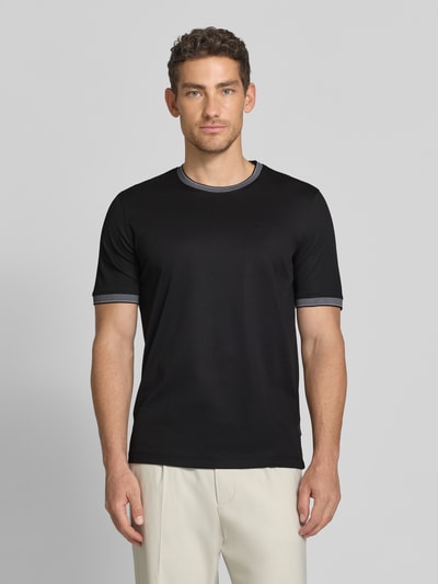 Mężczyznę model nosi T-Shirt mit Rundhalsausschnitt von bugatti, czarny kolor, bawełniany materiał, krój regular fit, widoczne detale label, długość tyłu 70 cm w rozmiarze M, całkowity widok z przodu.