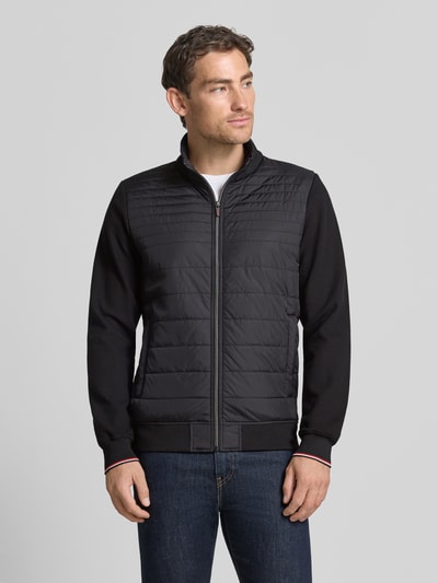 Männermodel trägt Steppjacke aus Baumwoll-Mix von Christian Berg Men, Dopasowany krój, Mieszanka bawełny i elastanu, Stójka, Rękawy z dzianiny dresowej, zamek błyskawiczny, wpuszczane kieszenie, prążkowane wykończenia, długość tyłu w rozmiarze M: 67 cm, długość rękawów w rozmiarze M: 66 cm, całkowity widok z przodu.