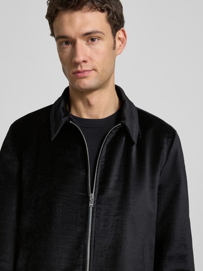 Männermodel trägt Hemdjacke mit Reißverschluss Modell 'RIKKA' von Drykorn aus schwarzem Viskose-Baumwoll-Mix, Nahaufnahme Oberkörper. Herren, Regular-Fit, Kentkragen, Eingrifftaschen, Rückenlänge 68 cm, Schulterbreite 45 cm, Brustweite 57 cm, Ärmellänge 64 cm.
