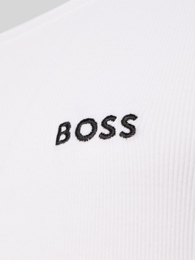 Männermodel trägt Slim Fit Unterhemd aus reiner Baumwolle im 3er-Pack Modell 'ONE' von BOSS, weiß, Feinripp, Nahaufnahme Oberkörper. Optik: Unifarben, Passform: Slim-Fit, Label-Applikation, U-Ausschnitt, breite Träger, Multipack: 3er-Pack, Materialverarbeitung: Feinripp, Material: Reine Baumwolle.