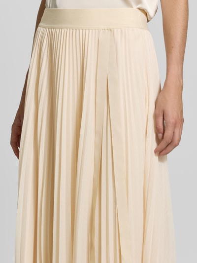 Frauenmodel trägt Plisseerock mit elastischem Bund von V by Vera Mont, beigefarbener Chiffon, A-Linie, Nahaufnahme Oberkörper.