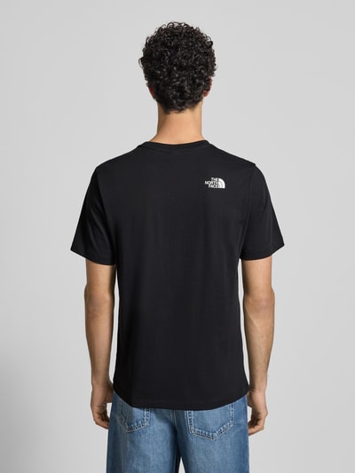 Männermodel trägt zwart Regular fit T-shirt aus puur katoen Model 'MOUNTAIN LINE' van The North Face met labelprint, ruglengte 70 cm, ganzkörperansicht rückansicht
