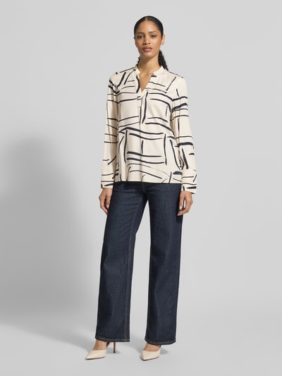 Frauenmodel trägt Regular Fit Hemdbluse aus reiner Viskose von Tommy Hilfiger mit Allover-Muster und V-Ausschnitt, feine Webstruktur, Ganzkörperansicht von vorne.