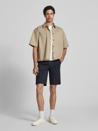 Männermodel trägt Regular Fit Shorts mit elastischem Bund Modell 'MARCO' von Blend aus Baumwoll-Elasthan-Mix, dunkel, Ganzkörperansicht von vorne. Shorts im Regular-Fit, Bundweite 39 cm in Größe M, Innenbeinlänge 27 cm.