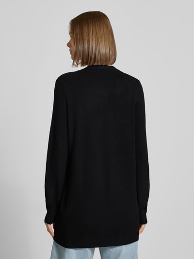 Frauenmodel trägt Regular Fit Strickjacke aus Viskose-Mix Modell 'MARY' von ONLY in Schwarz, strukturierte Oberfläche, Ganzkörperansicht Rückansicht, Damen Strickjacke von ONLY.