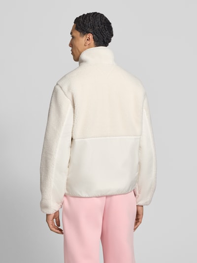 Männermodel trägt Regular Fit Webpelzjacke in Teddy-Optik von Tommy Jeans, cremefarben mit glatter und flauschiger Textur, Ganzkörperansicht Rückansicht. Kontext: Herren Teddy- / Webpelzjacke von Tommy Jeans.