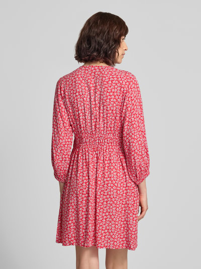 Frauenmodel trägt Minikleid aus reiner Viskose mit floralem Allover-Print von GAP, rot-weiß, tailliert, 3/4-Arm, Rückansicht, Ganzkörperansicht.