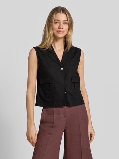Frauenmodel trägt Weste aus Leinen-Mix mit Pattentaschen Modell 'Lava' von FREE/QUENT in Schwarz, Reverskragen, Knopfleiste, Ganzkörperansicht von vorne. Regular Fit, Struktur durch Viskose-Anteil, dezente Textur, Rückenlänge ca. 50 cm, Schulterbreite ca. 40 cm, Brustweite ca. 48 cm.