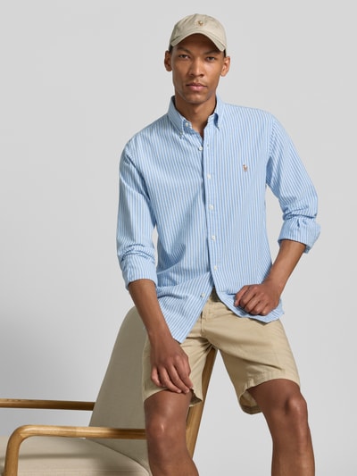 Männermodel trägt Regular Fit Freizeithemd aus reiner Baumwolle von Polo Ralph Lauren in hellblau-weiß gestreift, Ganzkörperansicht von vorne.