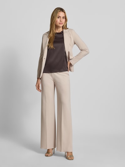 Vrouwenmodel draagt Straight Fit stoffen broek met persplooien van Rinascimento in lichtbeige, materiaalmix met stretch, zij-steekzakken, elastische band, bandwijdte maat S 37 cm, binnenbeenlengte 82 cm, volledige lichaamsaanzicht van voren