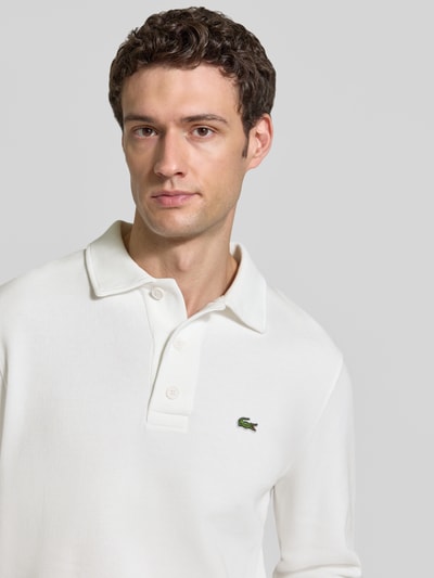 Männermodel trägt Regular Fit Sweatshirt aus reiner Baumwolle von Lacoste in Weiß, Struktur glatt, Nahaufnahme Oberkörper, Herren Sweatshirt von Lacoste.